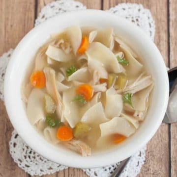 You won't believe how easy and delicious this Homemade Chicken Noodle Soup is! Make it on the stovetop or in a slowcooker or pressure cooker! #chickennoodlesoup #homemadesoup #pressurecooker #slowcooker #rotisseriechicken #easysouprecipe