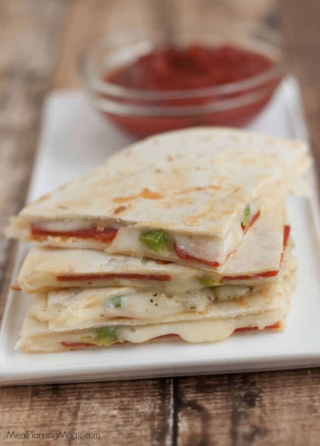 A tasty twist on a traditional quesadillas recipe that combines the favorite flavors of pizza, this recipe is quick and easy for a snack or light dinner! | Get the recipe at MealPlanningMagic.com