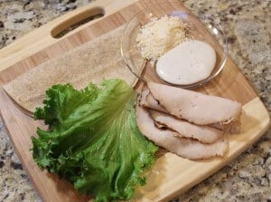 Ingredients to make a chicken Caesar salad wrap