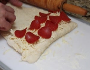 Making cheese and pepperoni pizza roll bread
