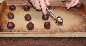 Panning scoops of cookie dough onto a baking sheet