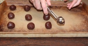 Panning scoops of cookie dough onto a baking sheet