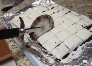 slicing goat cheese brownies into squares