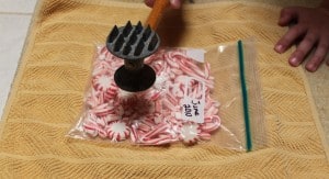 crushing peppermint candies with a meat tenderizer