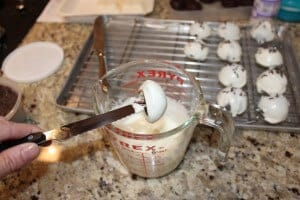 dipping cake balls into melted chocolate