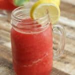 Watermelon Lemonade Slush in mason jar glass on wood background.