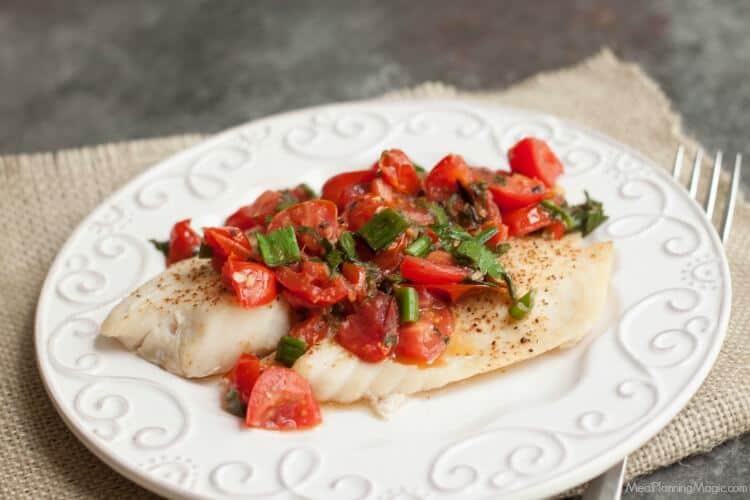 Super Simple Tomato Basil Topped Baked Fish tastes delicious and is budget friendly too! Get the recipe at MealPlanningMagic.com