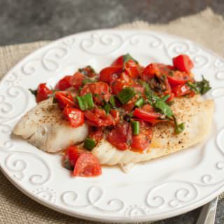 Super Simple Tomato Basil Topped Baked Fish tastes delicious and is budget friendly too! Get the recipe at MealPlanningMagic.com