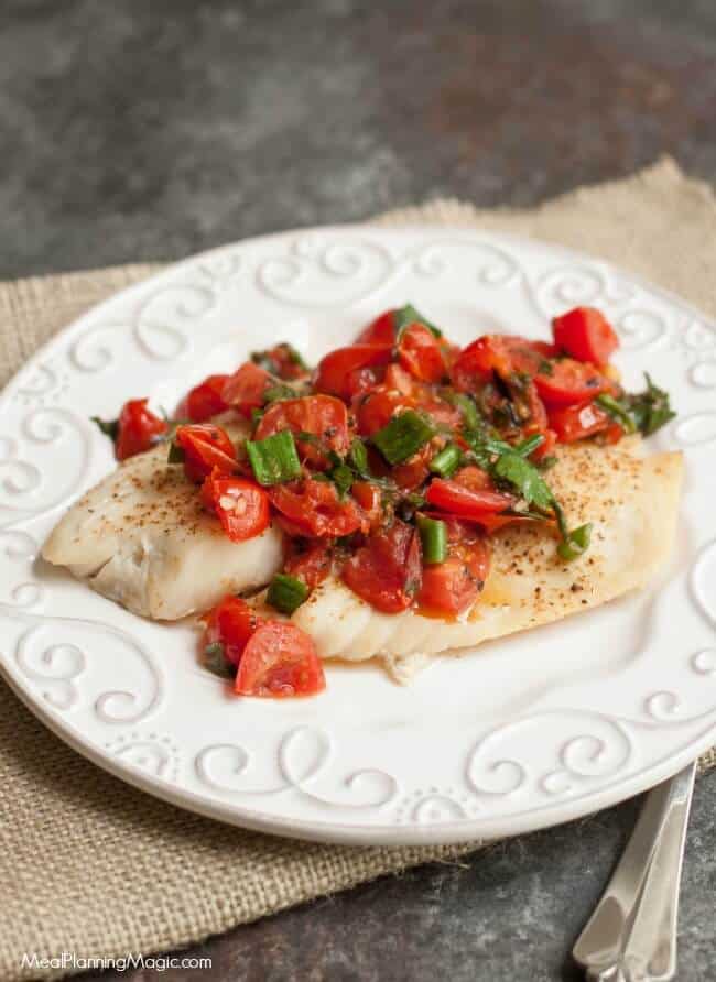Super Simple Tomato Basil Topped Baked Fish tastes delicious and is budget friendly too! Get the recipe at MealPlanningMagic.com