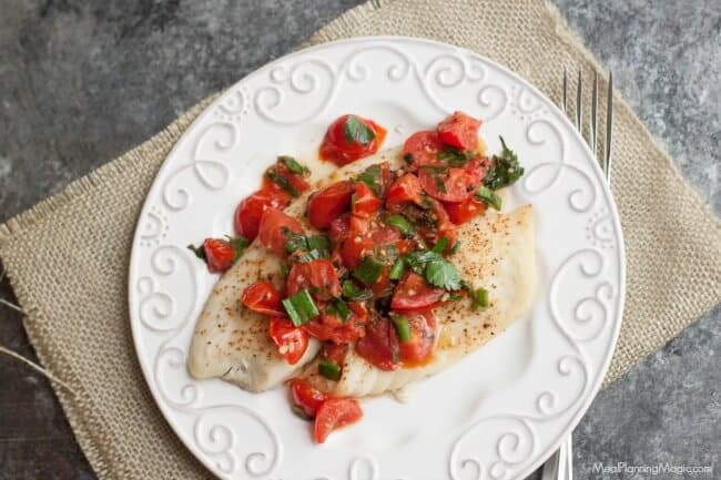 Super Simple Tomato Basil Topped Baked Fish tastes delicious and is budget friendly too! Get the recipe at MealPlanningMagic.com