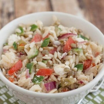 This Greek Lentil Orzo Salad a nutritious and economical way to enjoy fresh vegetables and lentils. It's make ahead too! Recipe at MealPlanningMagic.com