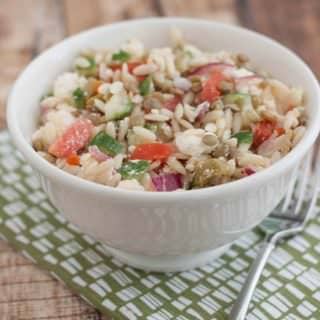 This Greek Lentil Orzo Salad a nutritious and economical way to enjoy fresh vegetables and lentils. It's make ahead too! Recipe at MealPlanningMagic.com