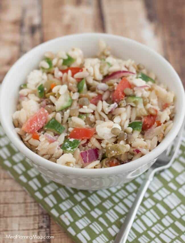 This Greek Lentil Orzo Salad a nutritious and economical way to enjoy fresh vegetables and lentils. It's make ahead too! Recipe at MealPlanningMagic.com