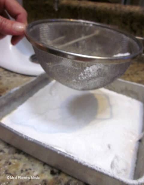 Dusting Homemade Salted Caramel Marshmallows with powdered sugar | 12 Weeks Christmas Treats hosted by MealPlanningMagic.com | #12wksxmastreats