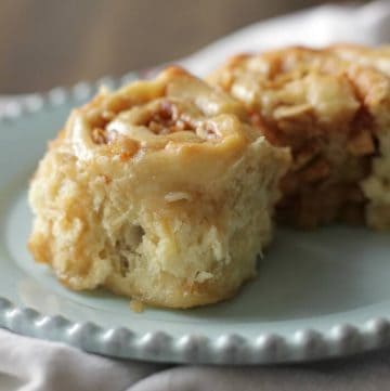 Two apple cinnamon rolls on a blue plate