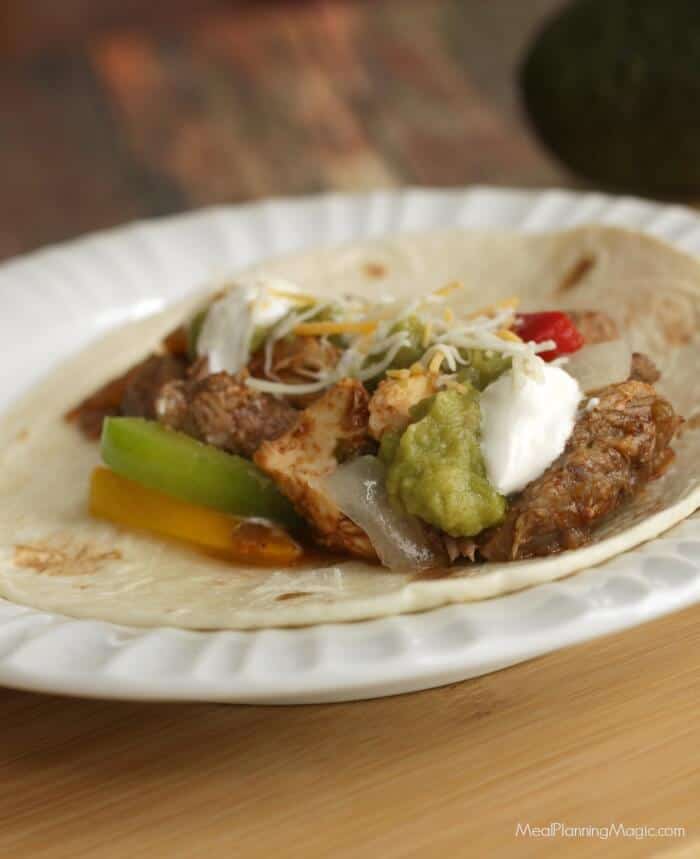 Simple Slowcooker Steak and Chicken Fajitas are a delicious and easy way to enjoy at Texas regional specialty. Perfect for a weeknight--or when company's visiting! Find the recipe at MealPlanningMagic.com