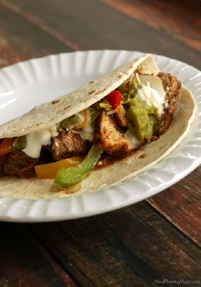 Simple Slowcooker Steak and Chicken Fajitas are a delicious and easy way to enjoy at Texas regional specialty. Perfect for a weeknight--or when company's visiting! Find the recipe at MealPlanningMagic.com