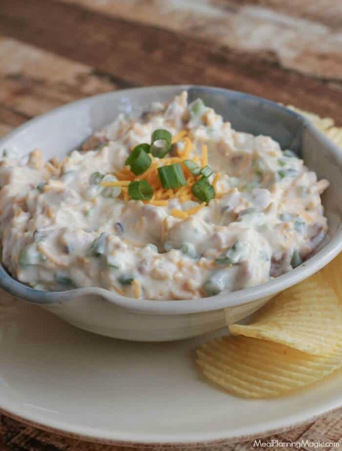 Loaded Baked Potato Dip-only four ingredients and oh, so delicious! It's one of our all-time favorite dips and perfect for any occasion! Get the recipe at MealPlanningMagic.com