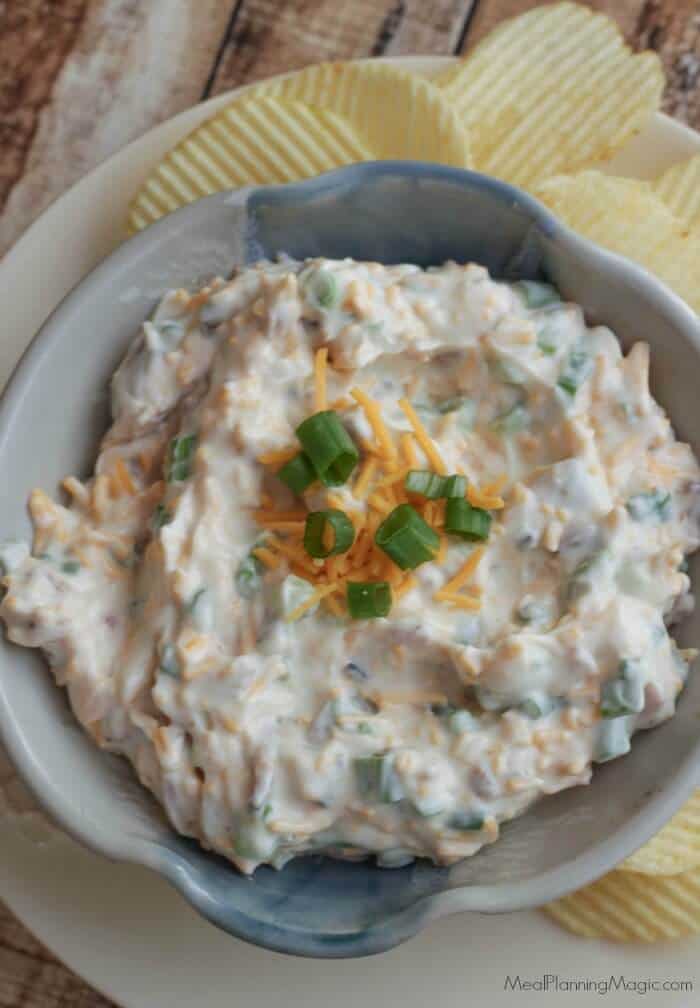 Loaded Baked Potato Dip-only four ingredients and oh, so delicious! It's one of our all-time favorite dips and perfect for any occasion! Get the recipe at MealPlanningMagic.com