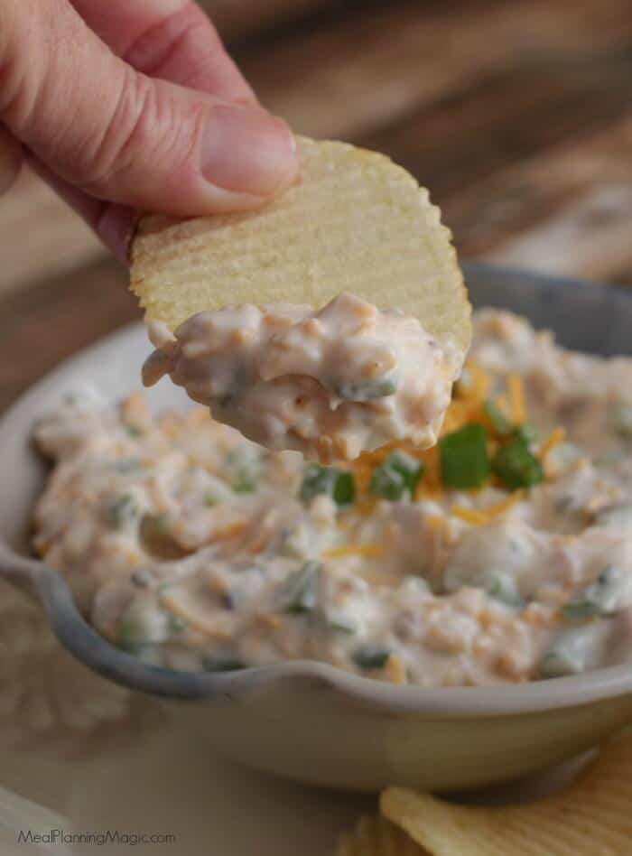 Loaded Baked Potato Dip-only four ingredients and oh, so delicious! It's one of our all-time favorite dips and perfect for any occasion! Get the recipe at MealPlanningMagic.com