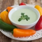 Creamy Jalapeno Ranch Dip in white bowl surrounded by colorful mini sweet peppers
