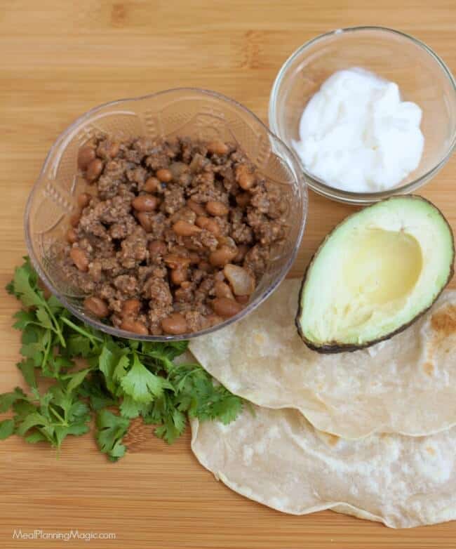 With just a few ingredients, these Easy Beef and Bean Burritos are not only simple to whip up, they are also budget friendly. They are a family favorite! Recipe at MealPlanningMagic.com