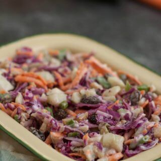 Filled with good for you vegetables, nuts and dried fruits, this Trailmix Coleslaw is easy to make ahead and do delicious too!