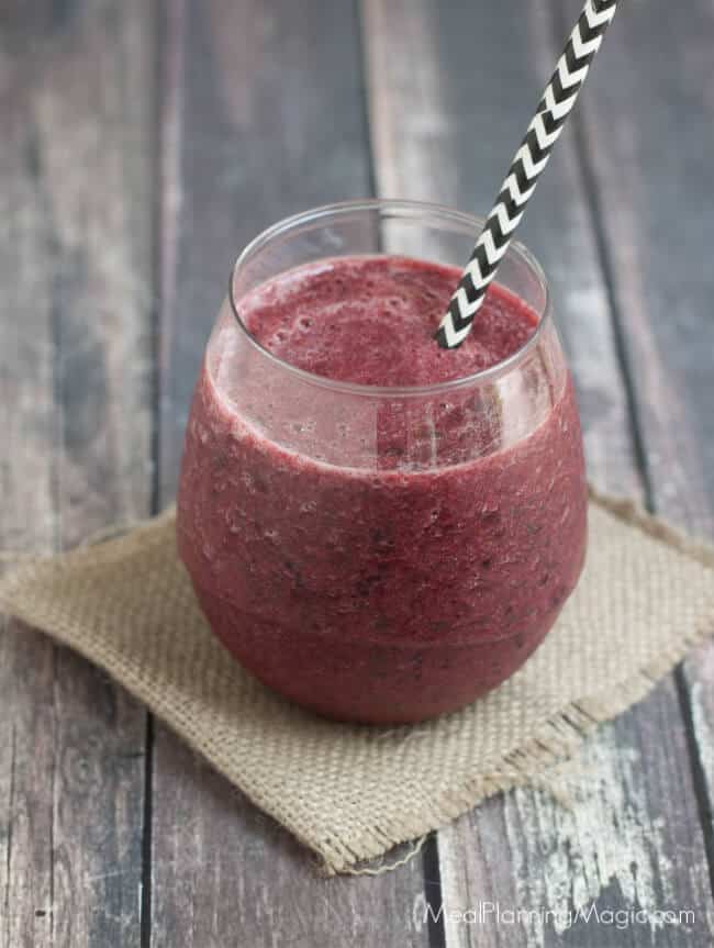 This Triple Berry Banana Green Smoothie is full of flavor and nutritious ingredients! It's a cinch to blend up on a busy morning or for an afternoon snack. Find the recipe at MealPlanningMagic.com #healthysmoothie #berrybananasmoothie #freshsmoothie #berrysmoothie image of Triple Berry Banana Green Smoothie