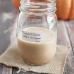 Image of Pumpkin Spice Latte Creamer in a jar with label and pumpkins in background.