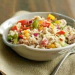 Italian Vegetable Wild Rice Salad in a pottery bowl on burlap napkin.