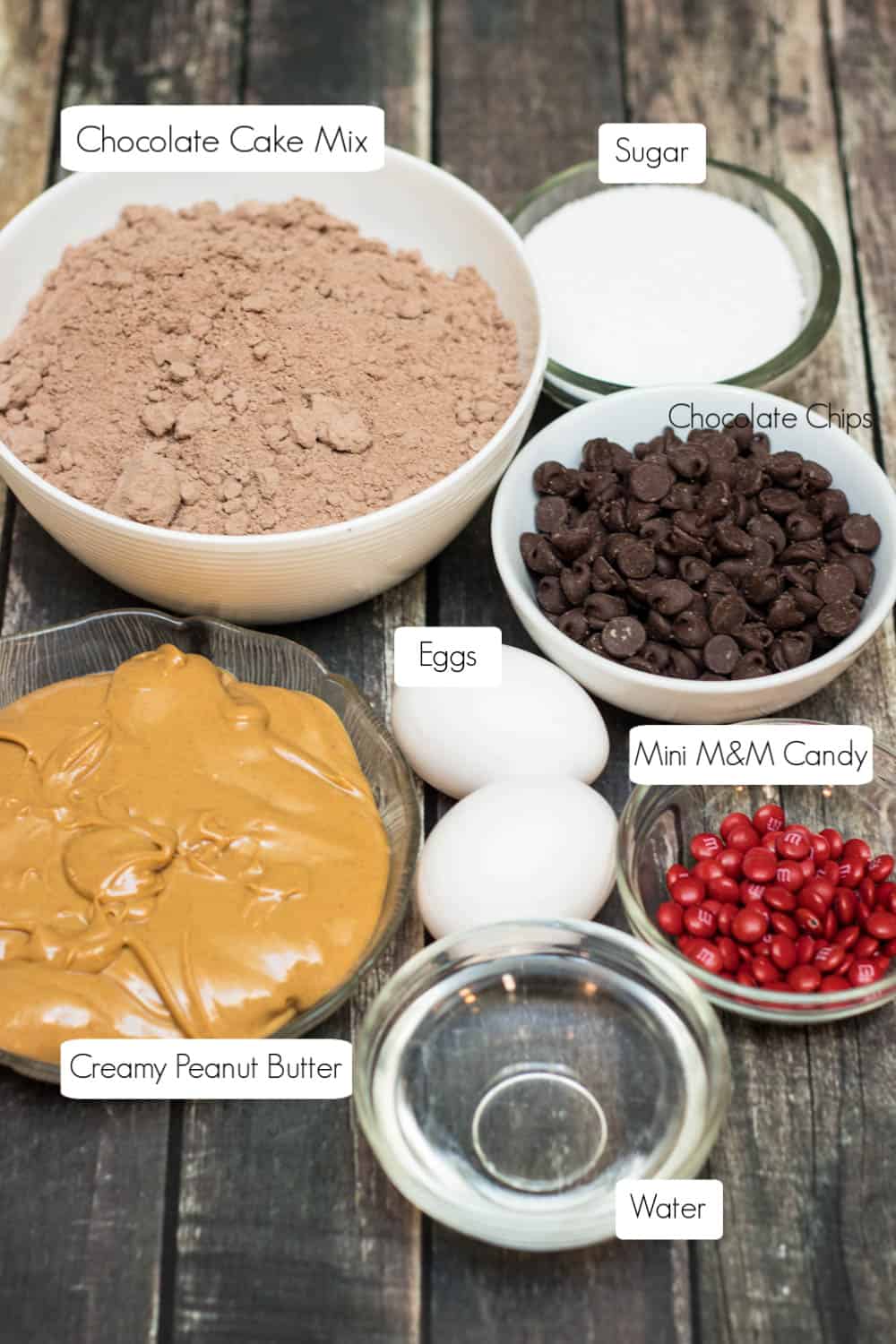 Ingredients in bowls for chocolate black cat cookies.