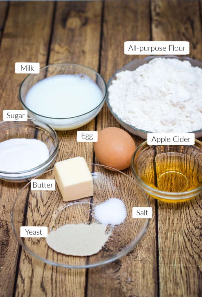 Labeled ingredients in bowls to make dough for cinnamon rolls.