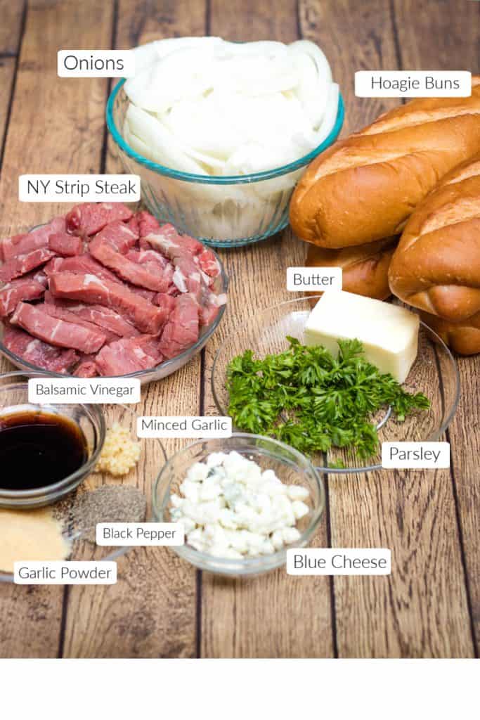 Steak and onion sandwich ingredients in bowls with labels for each.