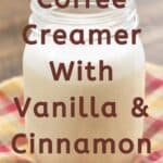 Glass jar of homemade cinnamon vanilla coffee creamer on a multi colored napkin with text overlay.