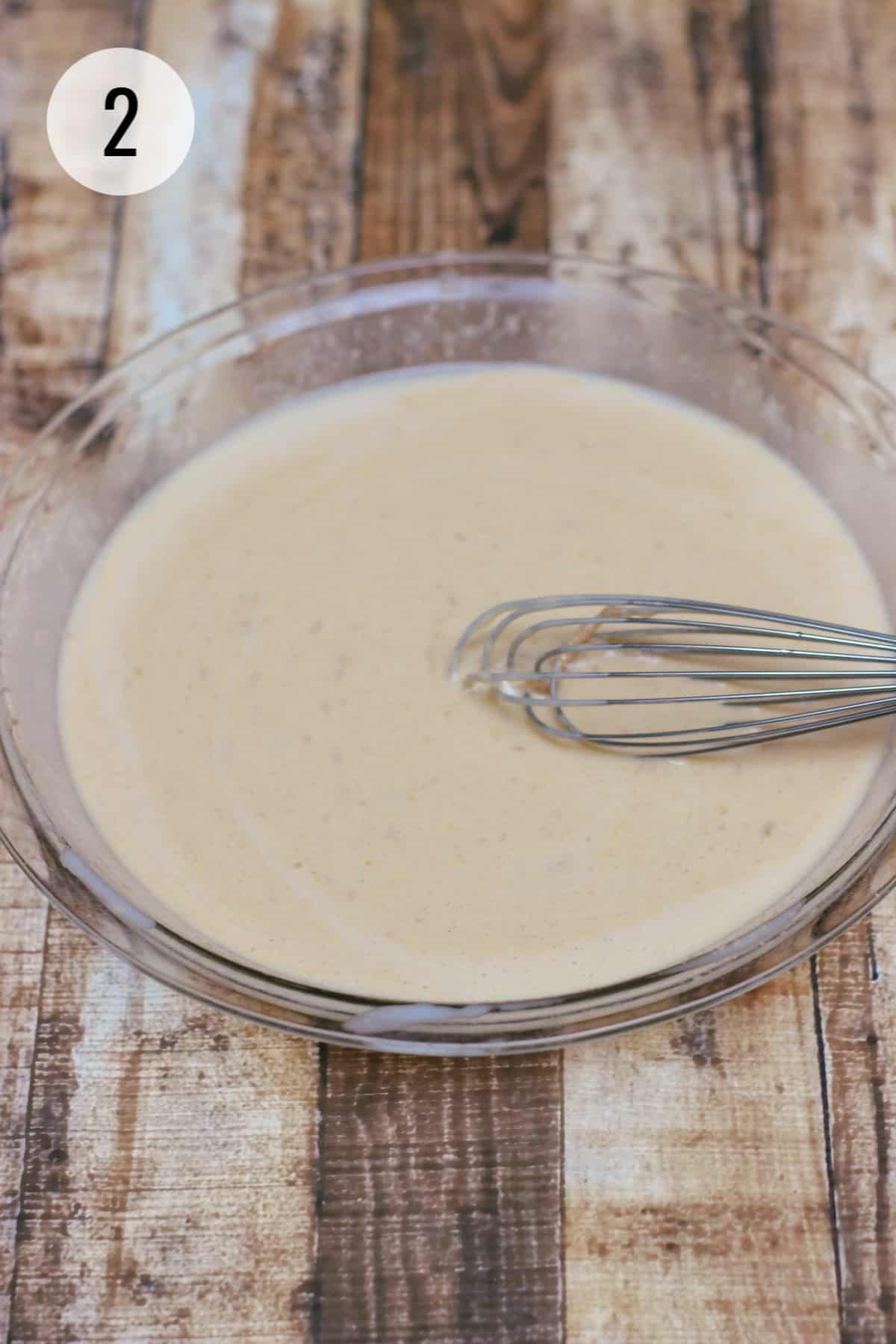 Blended mixture of peanut butter, coconut milk and eggs whisked in a pie plate. 