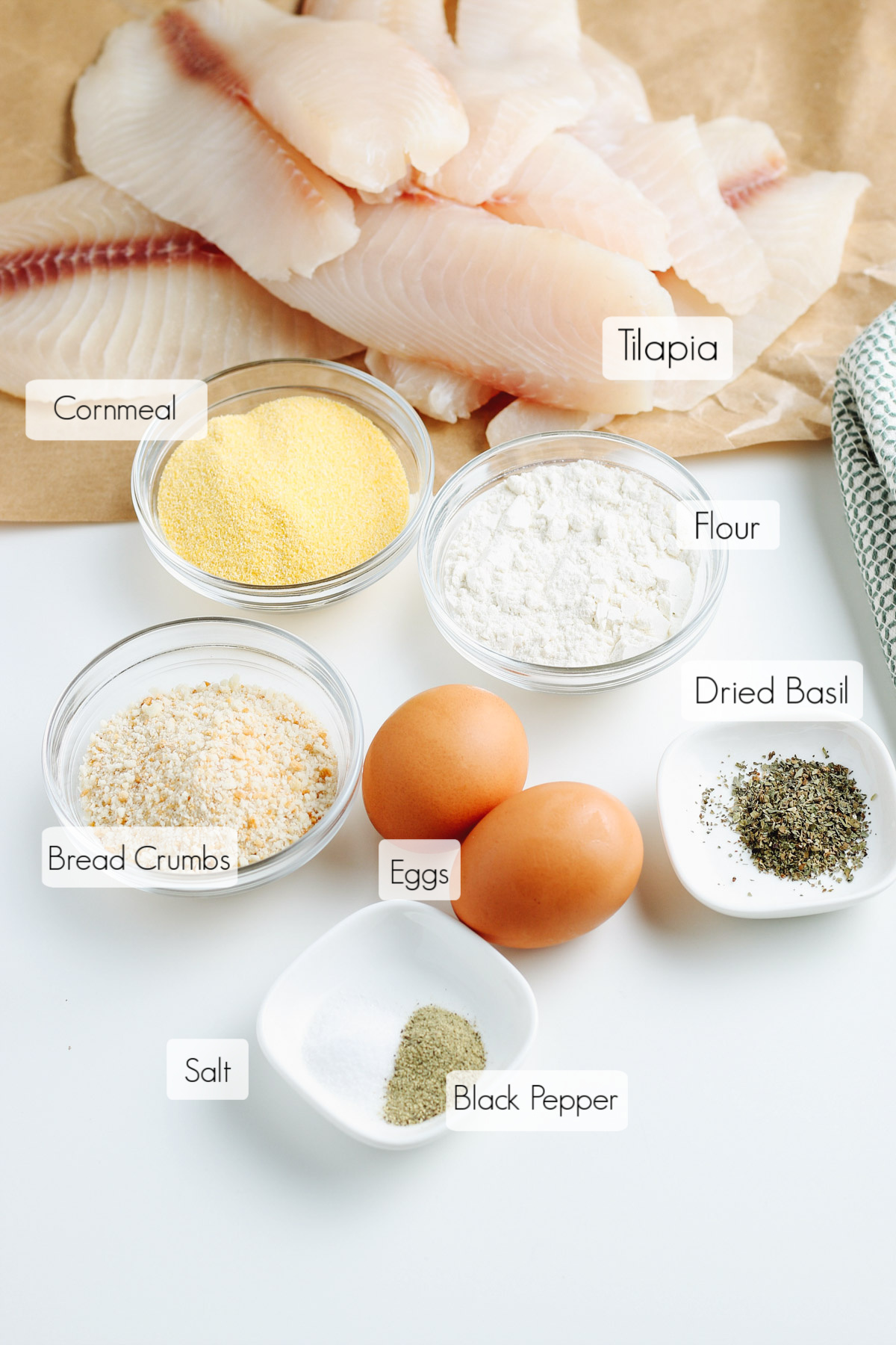 Labeled ingredients in bowls to make crunchy oven fried breaded tilapia. 