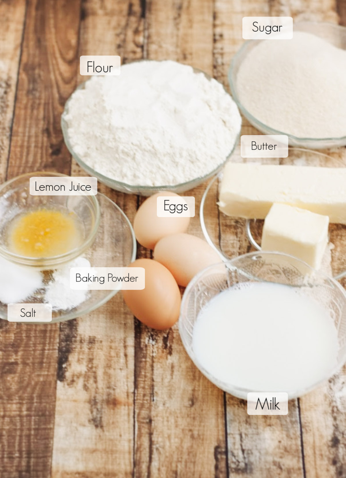 Ingredients to make moist pound cake recipe, in bowls with labels for each. 