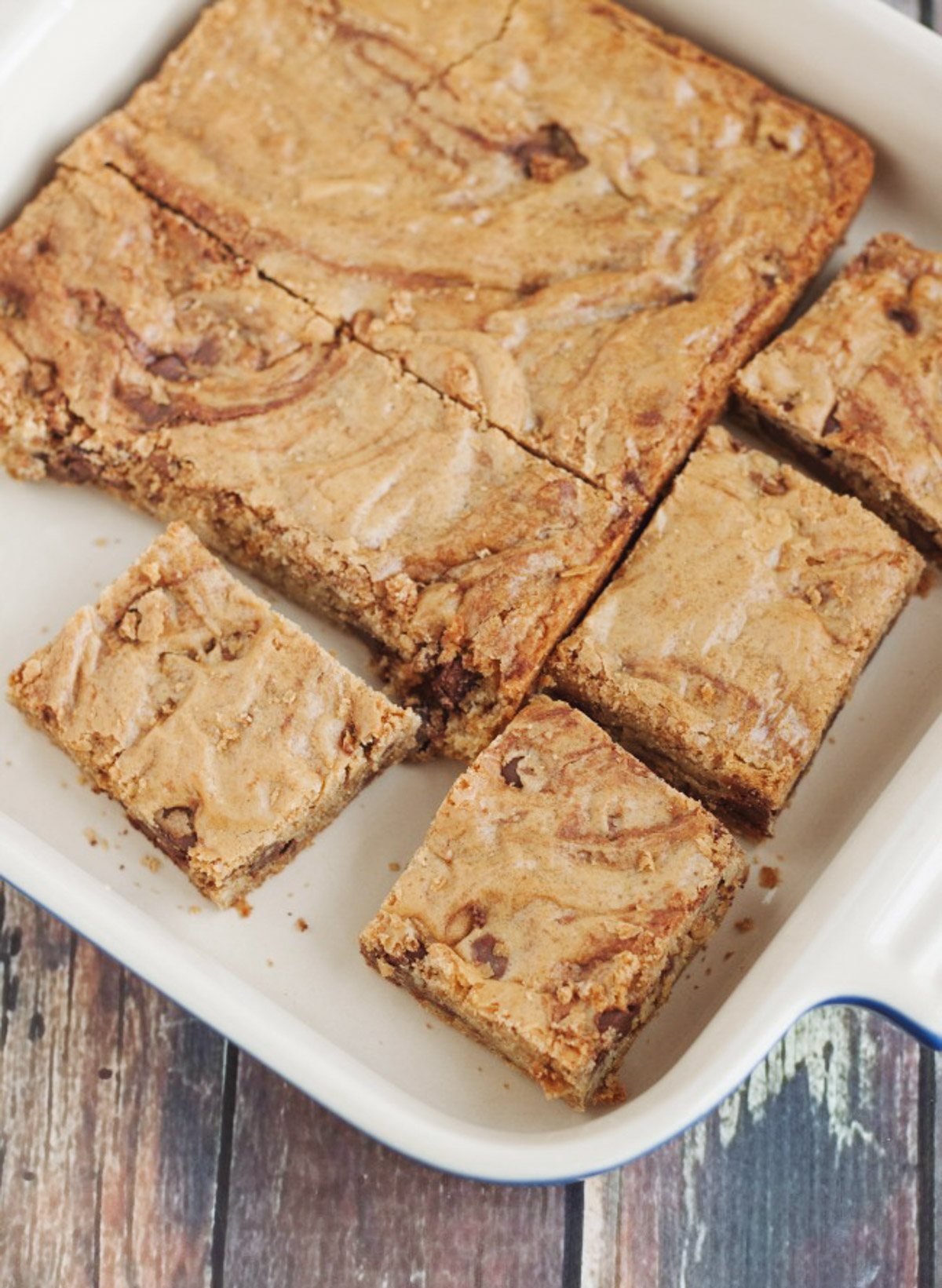 Baking pan with cut blondie bars with chocolate chips cut into squares. 