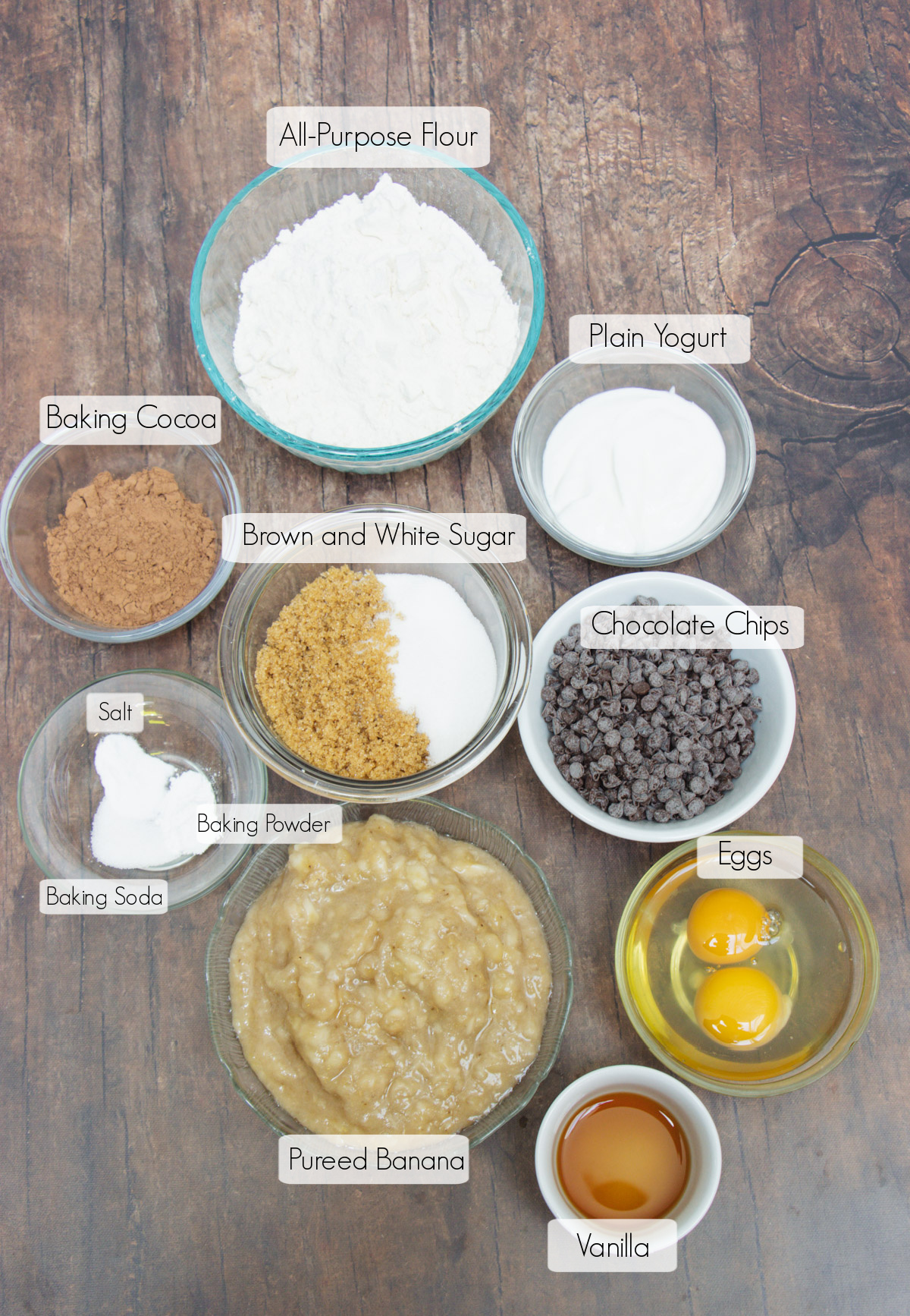 Labeled ingredients in bowls to make healthy chocolate chip banana bread.