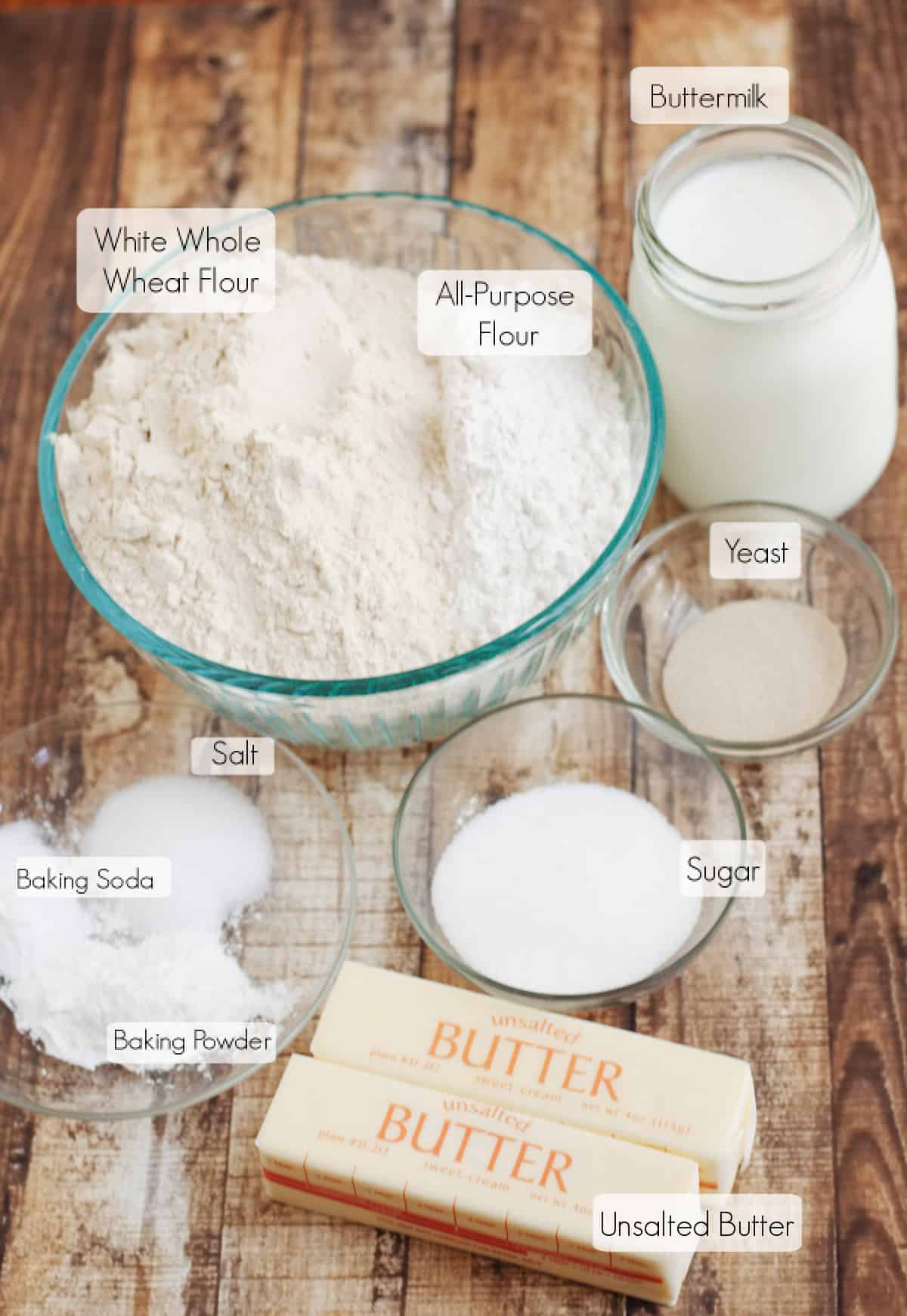 Labeled ingredients in bowls to make whole wheat biscuits.