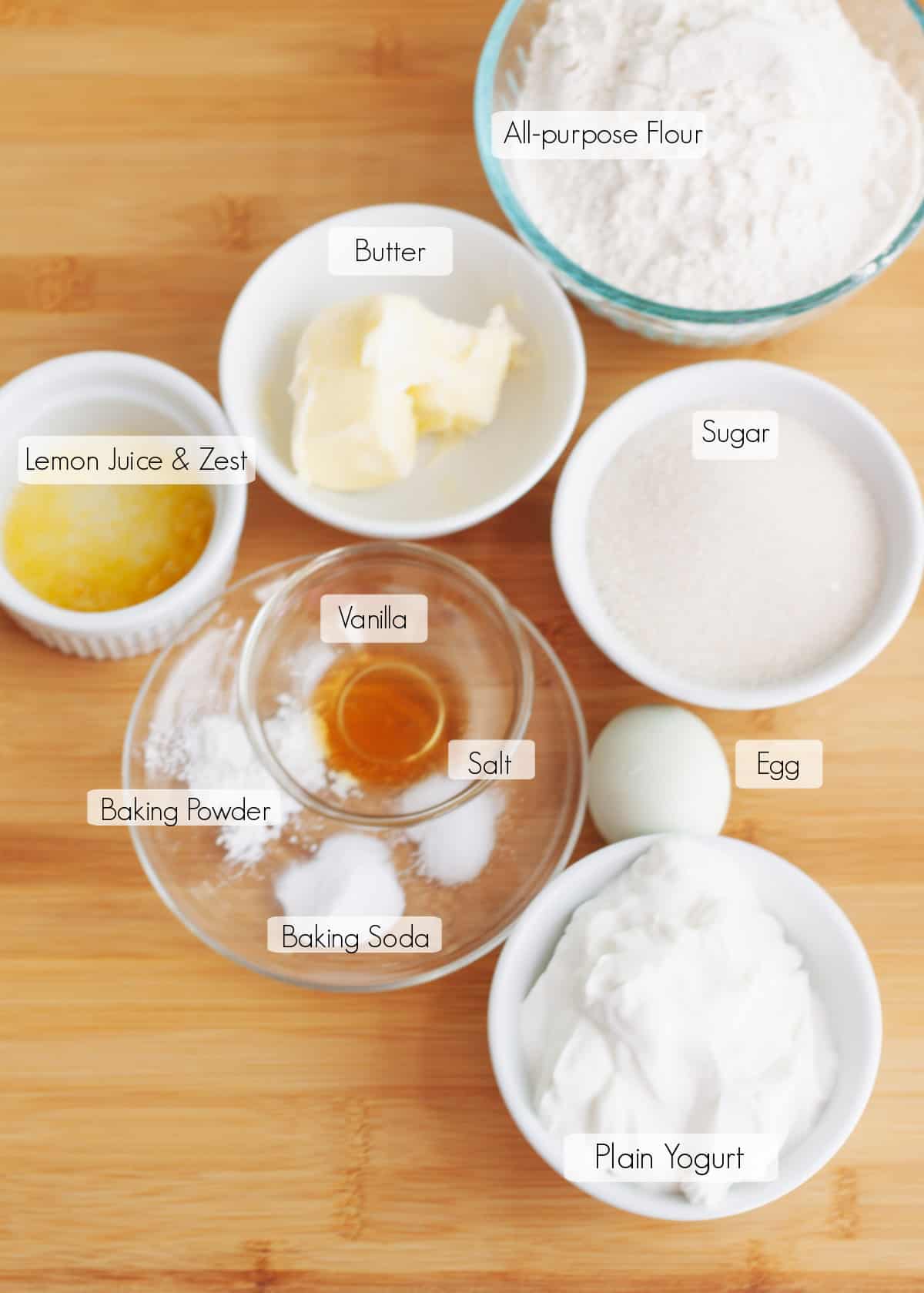 Labeled ingredients in bowls to make lemon bread recipe. 