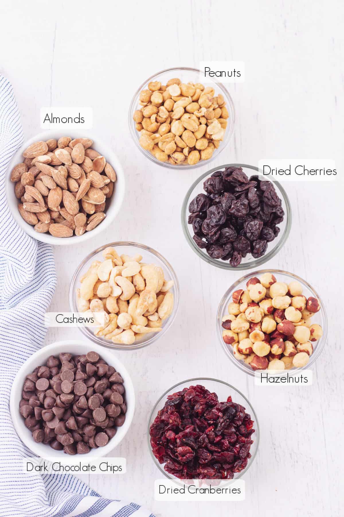 Labeled ingredients in small bowls to make Dark Chocolate Cherry Homemade Trail Mix.