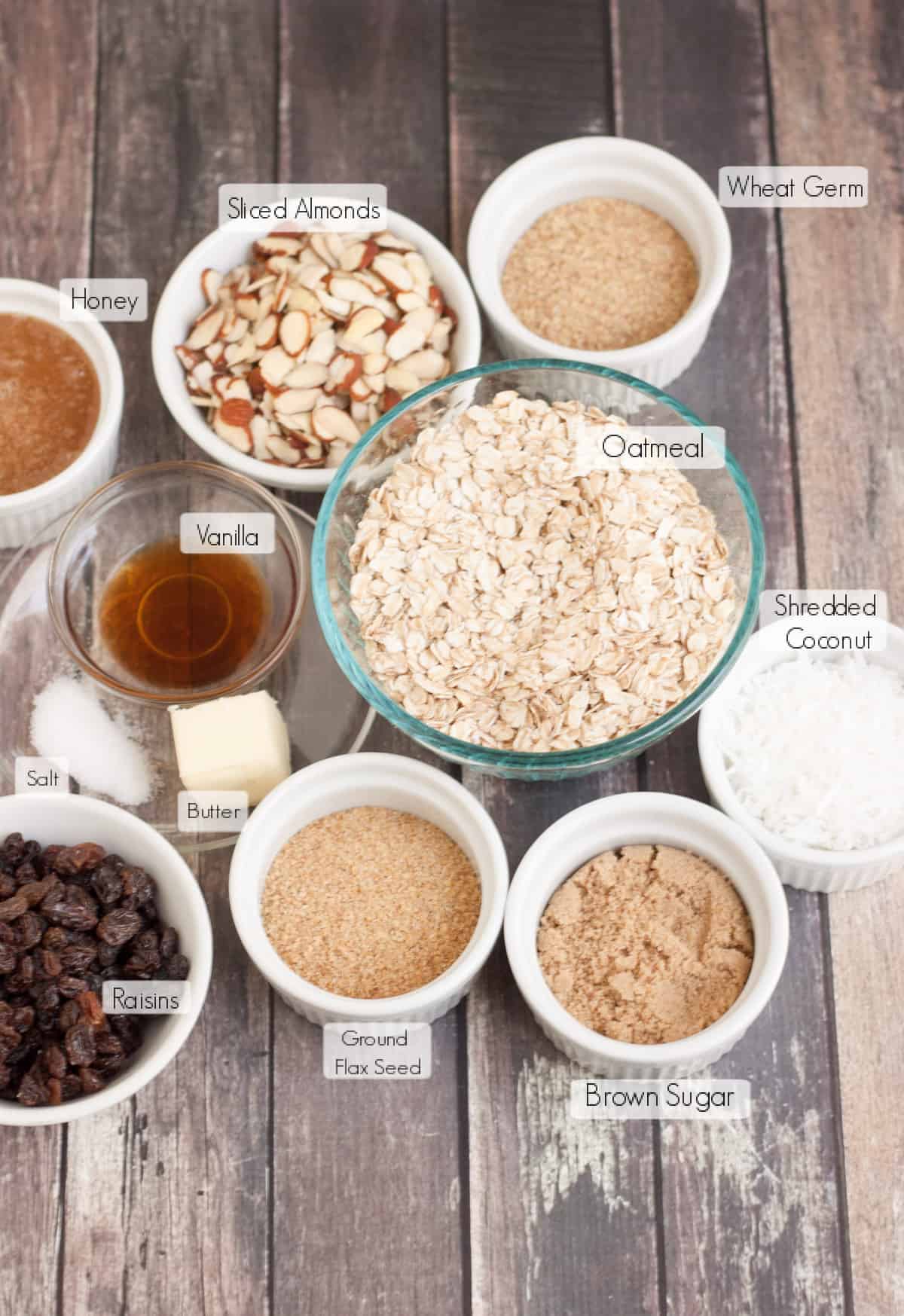 Labeled ingredients in bowls to make homemade granola bars. 