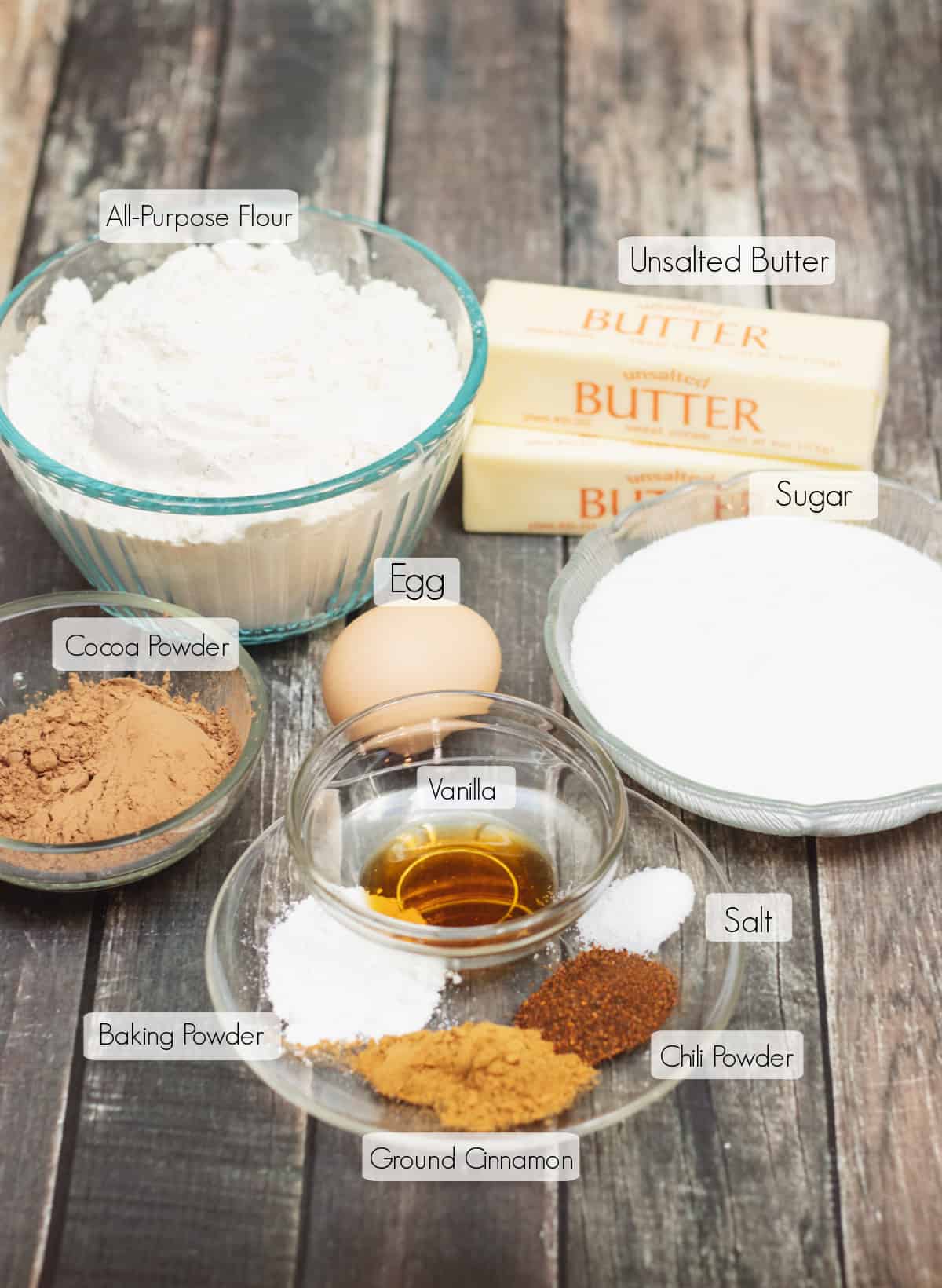 Labeled ingredients in bowls to make Mexican chocolate sugar cookies.