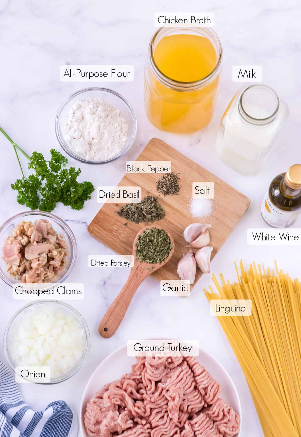 Labeled ingredients to make ground turkey and creamy clam sauce with linguine. 