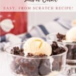 Small glass bowls with chocolate pudding cake topped with vanilla ice cream and red slow cooker and blue striped linen in background.